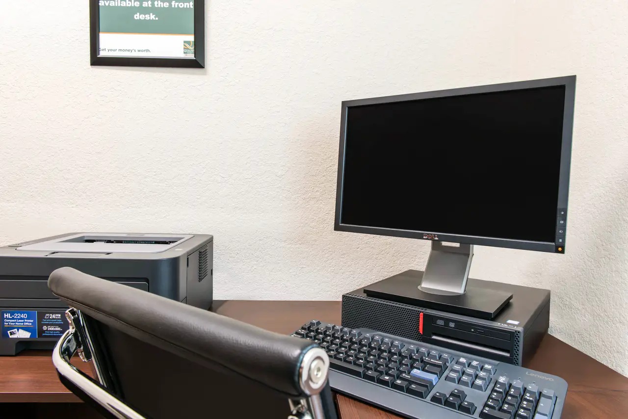 A business center with computers and a printer